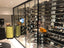 Basement glass enclosed wine cellar with horizontal wine bottle storage