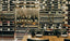 Mixed Metal and Wood Millesime Wine Wall in a Glass Enclosure with Display Top and Side Wine Racks