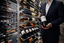 Waiter Holding a Bottle of Malbec Wine That Was on  a Millesime Wine Cellar in a Hospitality Business