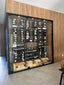 Modern glass enclosed wine cellar with storage for dozens of wine bottles